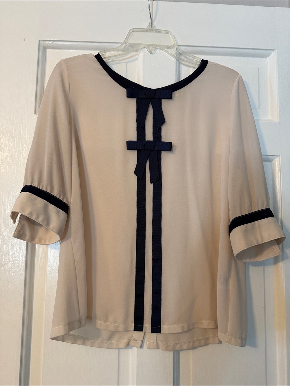 Red Dress Boutique Cream Blouse with Navy Trim and Bow Detail